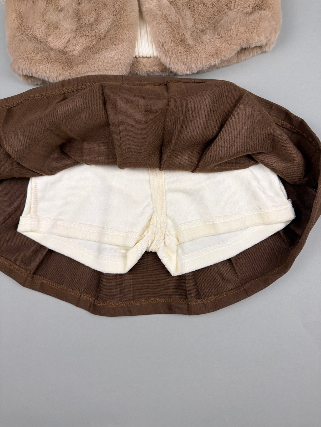 Fur vest with fleece top and corduroy skirt